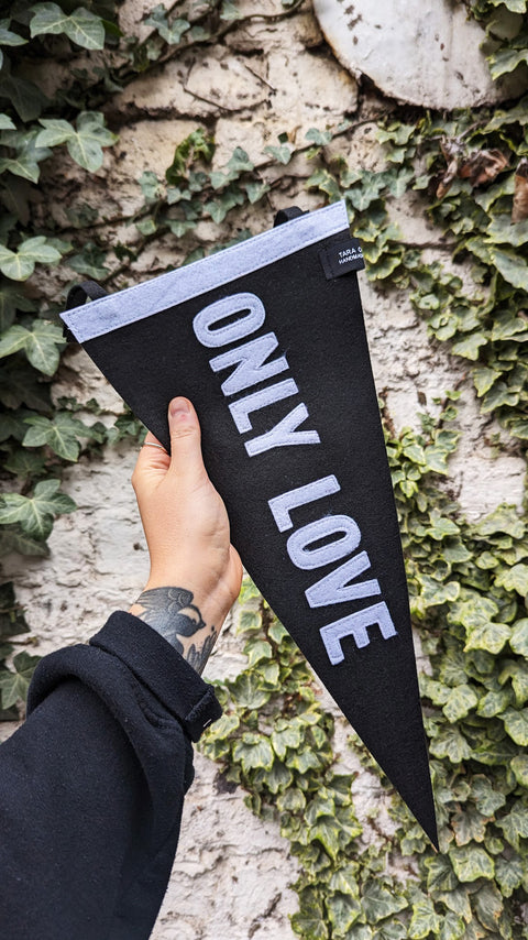 Pennant banner in black and white with "only love" text on.