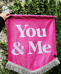 Velvet wedding banner in pink with "you and me" white text and silver fringing