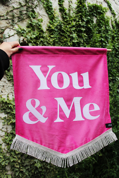 Velvet wedding banner in pink with "you and me" white text and silver fringing