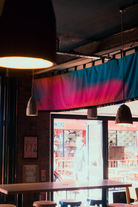 Back view of interior horizontal banners with "Common X Nell's" text in bar