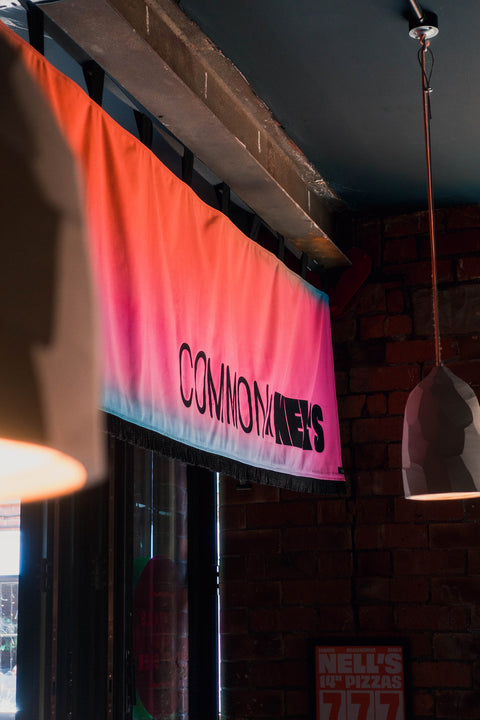 Interior horizontal banner with "Common X Nell's" text in bar