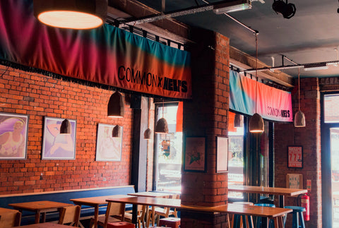 Interior horizontal banners with "Common X Nell's" text in bar