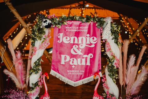 Velvet larg wedding banner with name of couple shown in venue at event.