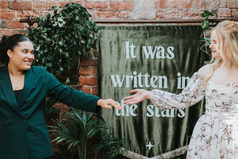 Velvet large wedding banner with name of couple shown in venue at event.