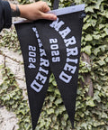 Pennant banners in black and white with "married" and the year text on ivy leaf background.