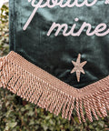 Green velvet banner with fringing and star details.