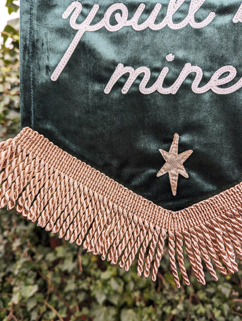 Green velvet banner with fringing and star details.