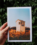 Hand holding A5 risograph print of Cleethorpes North Sea Lane station hut.