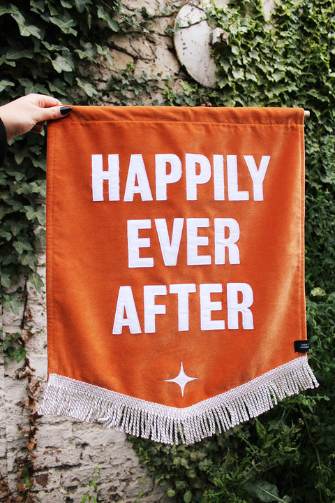 Velvet wedding banner in orange with "happily ever after" text, white fringing and star applique.