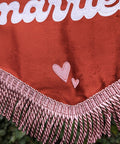 Velvet banner in terracotta showing close up of pink fringing and pink heart appliques.