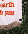 Baby pink velvet banner with close up of red "heaven is a place on earth with you" text outlined in shiny gold.