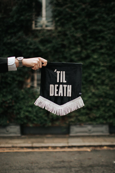 Velvet wedding mini banner in black with "til death" text and white fringing.