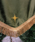 Close up of wedding banner with gold fringing and gold applique star.